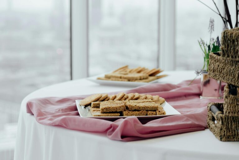Tasty biscuits displayed on a pink linen-covered table with blurred background.